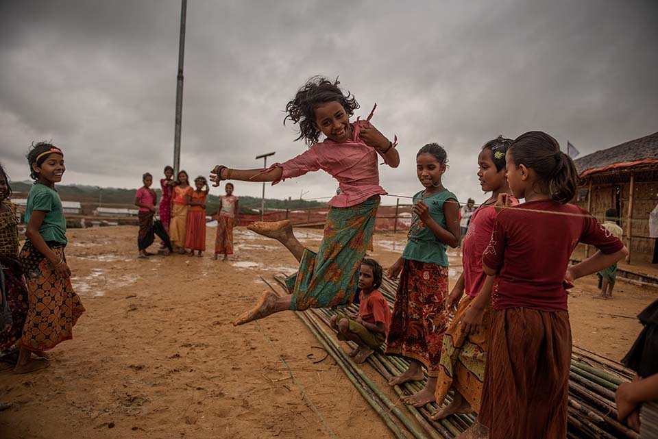 a Rohingya refugee girl plays in a camp in Bangladesh