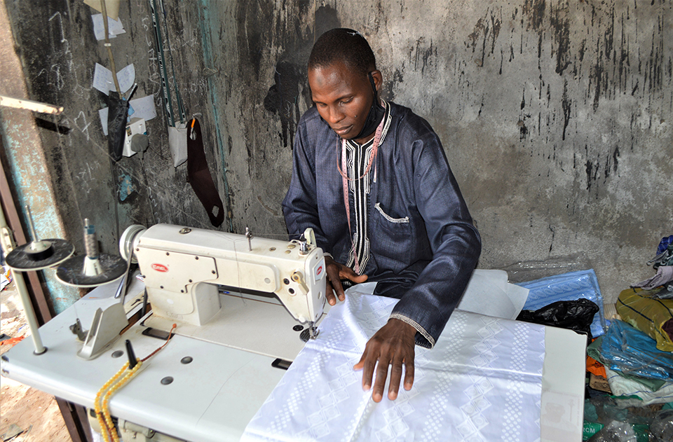 clothing maker in his shop in Nigeria