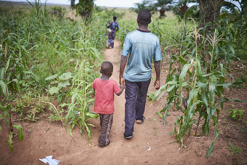 family walks in DR Congo field