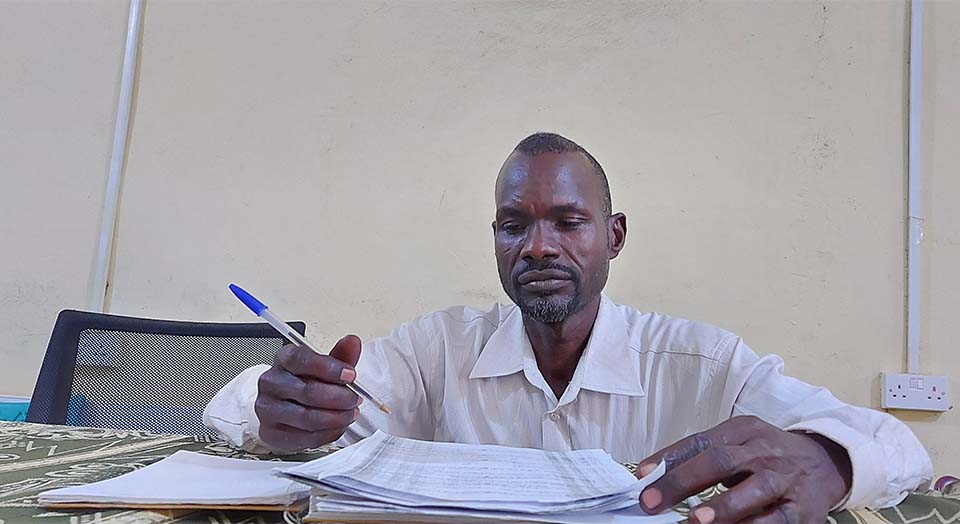 Sudanese project officer at his desk in West Darfur, Sudan