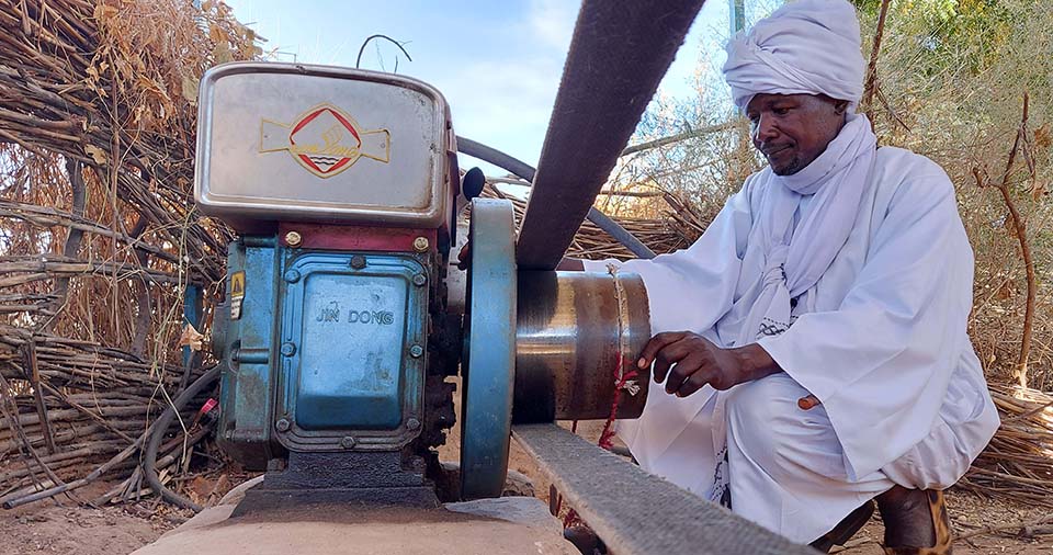Sudanese savings group leader checks grinding mill operations