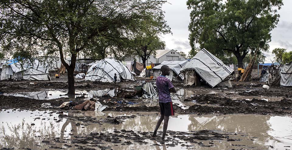 South Sudanese person stands in flooded camp