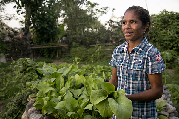 Joana Mascarenhas tends a model garden, which demonstrates different planting techniques to help families learn to grow more nutritious foods and sell surplus produce. 