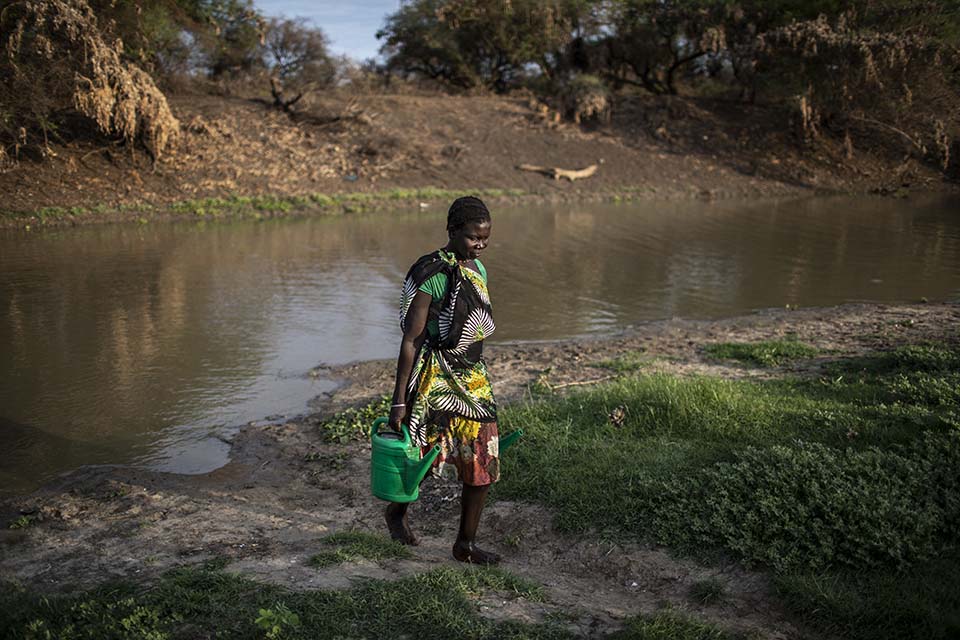 woman carries water in a jerry can in South Sudan
