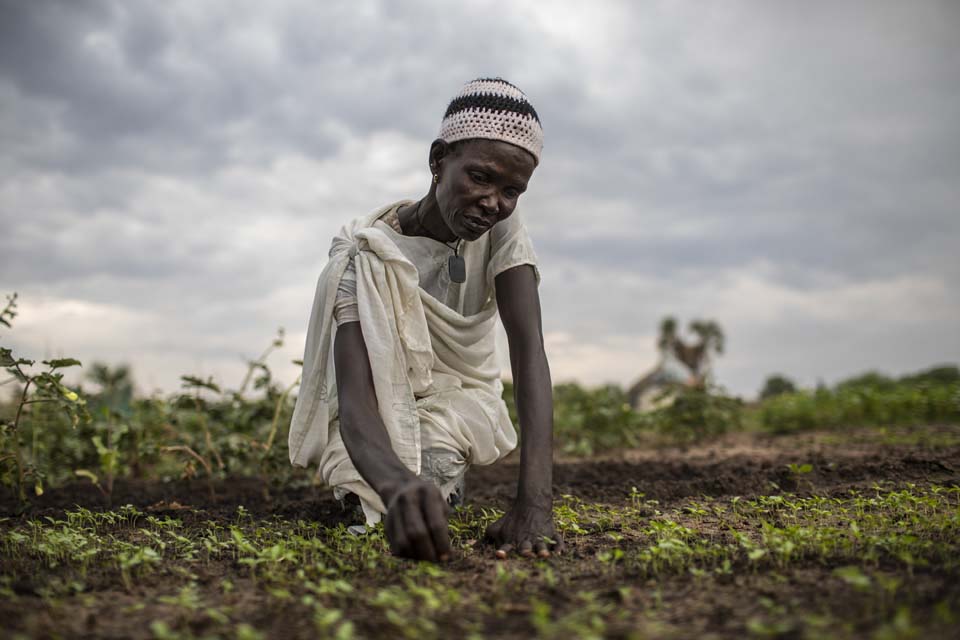 woman tends her crops in South Sudan
