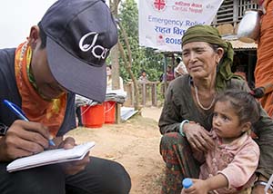 worker talks to earthquake survivor in Nepal