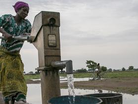 A woman in Jawani village utilizes a community borehole that was constructed with support from Catholic Relief Services in Ghana. 