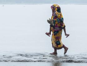 Mother walking to relief center in Bangladesh