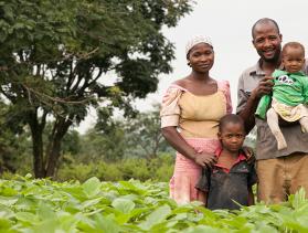 A Nigerian woman stands with her family