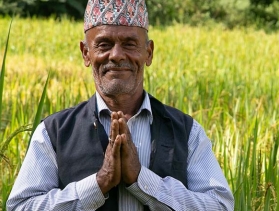 Nepal man facing camera, folded hands