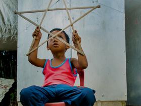 Ryle Andre Dalde plays with his Christmas star lantern.